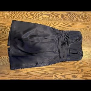 Dark purple strapless knee length dress with pockets.